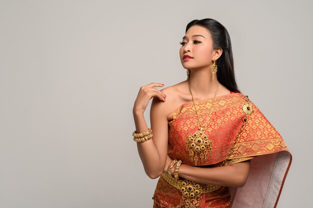 Woman wearing Thai dress that made a hand symbol