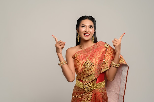 Woman wearing Thai dress that made a hand symbol