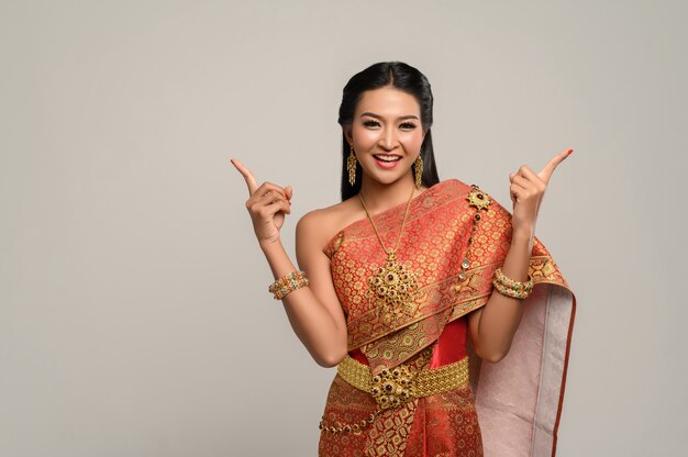 Woman wearing Thai dress that made a hand symbol