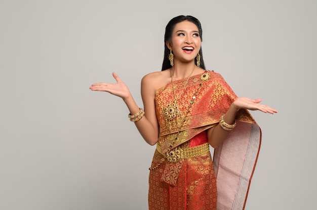 Woman wearing Thai dress that made a hand symbol