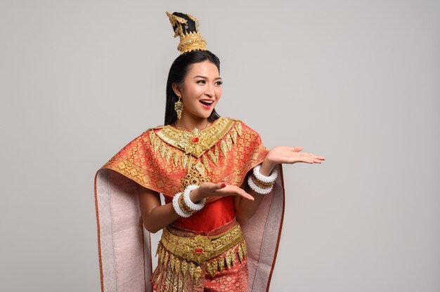 Woman wearing Thai dress that made a hand symbol