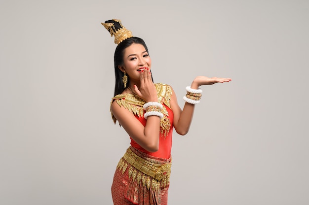 Free photo woman wearing thai dress that made a hand symbol