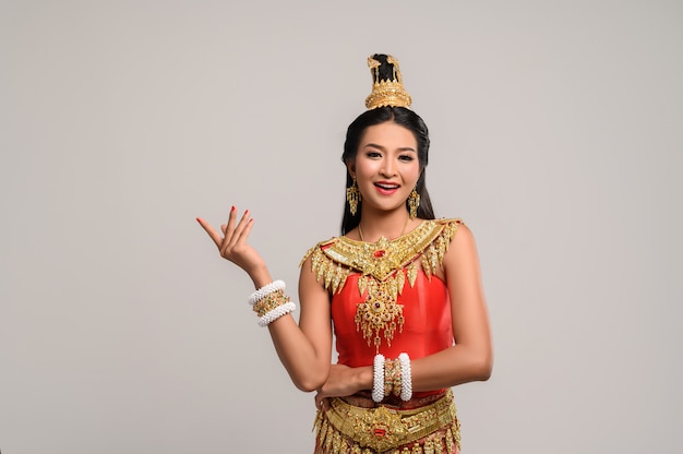 Woman wearing Thai dress that made a hand symbol