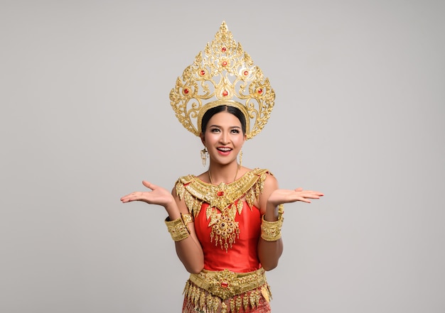 Woman wearing thai dress that made a hand symbol