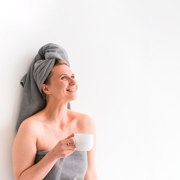 Woman wearing towels looking up