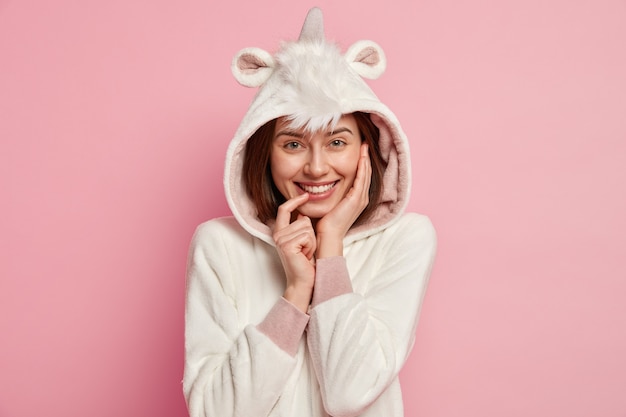 Free photo woman wearing unicorn pajamas