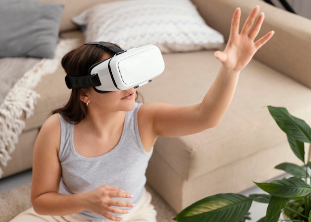 Woman wearing vr glasses at home