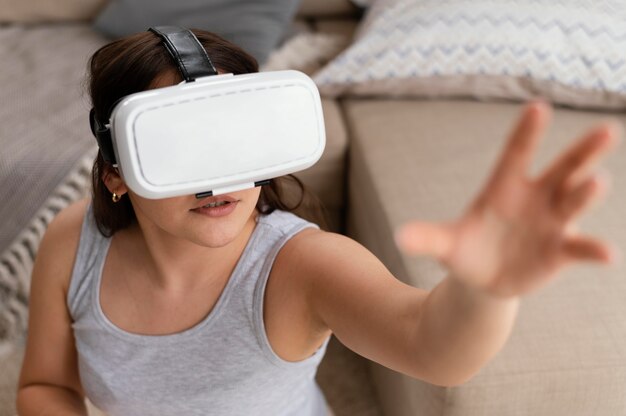 Woman wearing vr glasses in living room