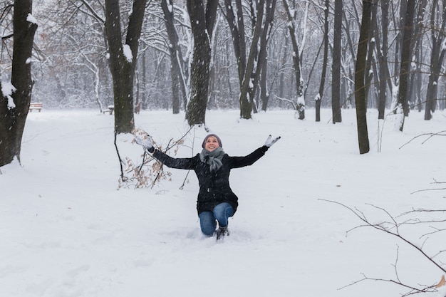 Woman wearing warm clothes enjoying in forest