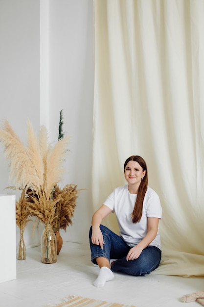 Woman wearing white blank tshirt standing on the background