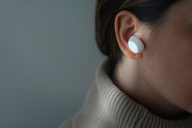 Woman wearing white wireless earbuds