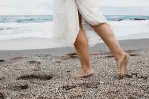 Free photo woman in wedding dress on the beach