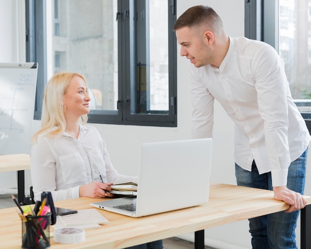 Woman in wheelchair conversing with make colleague