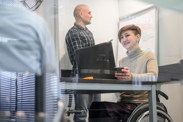 Woman in wheelchair and coworkers