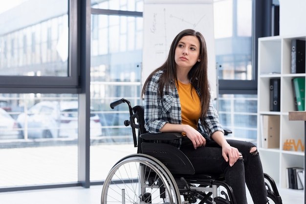 Woman in wheelchair looking away