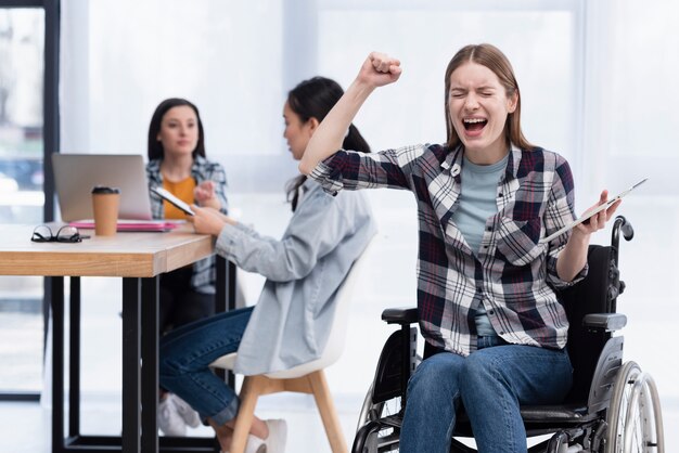 Woman in wheelchair with tablet