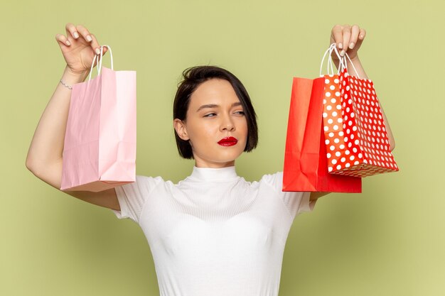 woman in white blouse and green skirt holding shopping packages