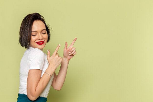 woman in white blouse and green skirt posing with smile 