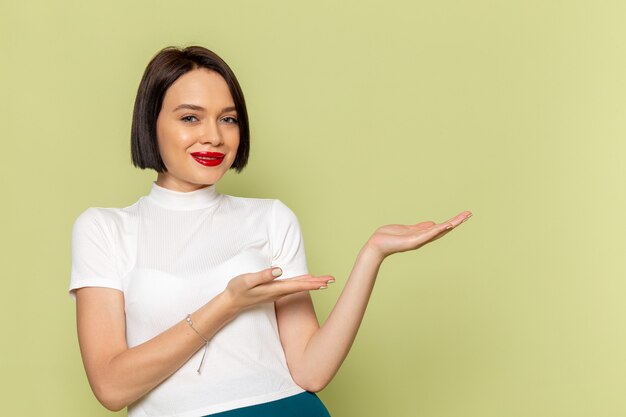 woman in white blouse and green skirt posing with smile 