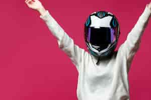 Free photo woman in white pullover with motorcycle helmet