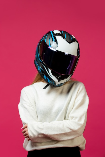 Free photo woman in white pullover with motorcycle helmet