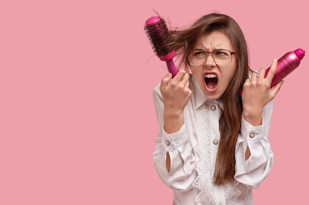 Free photo woman in white shirt styling her hair