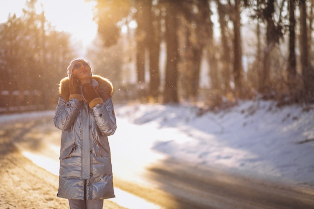 Woman in a winter park talking on the phone