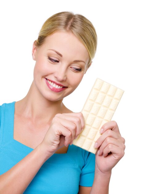 The woman wishes to eat a tile of sweet white chocolate