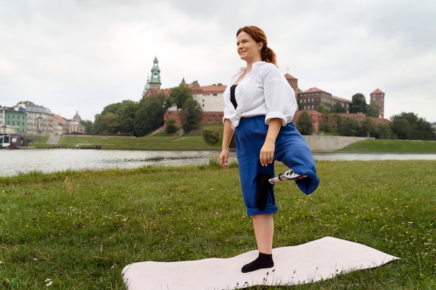 Foto gratuita donna con gamba protesica che fa yoga