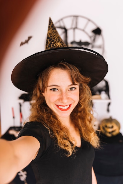 Woman in witch costume and pointy hat