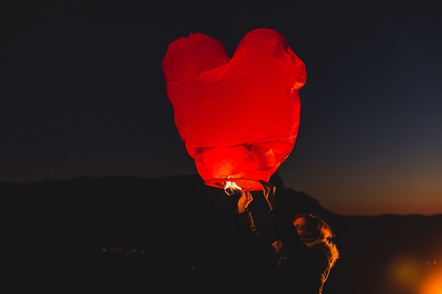 無料写真 夜に熱い空気の凧を持つ女性