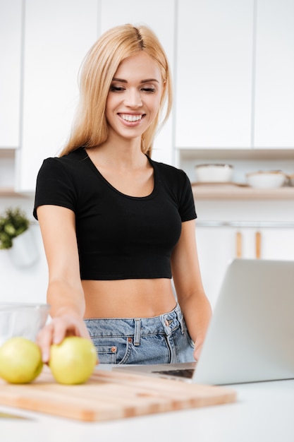 Woman with apple and laptop