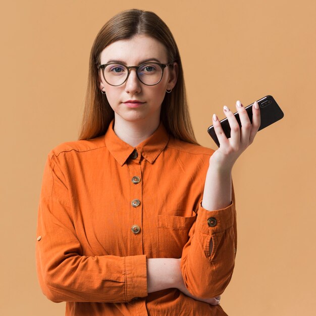 Woman with arms crossed holding mobile