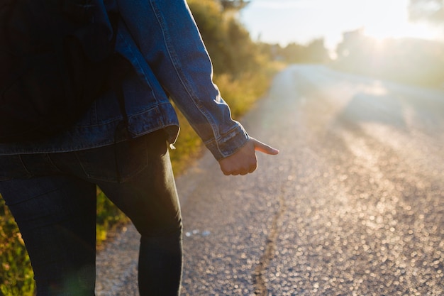 Woman with backpack hitchhiking