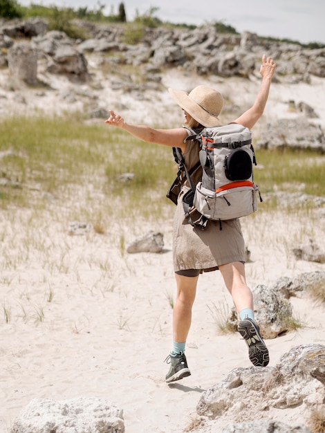 Free photo woman with backpack jumping