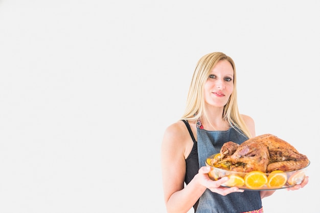 Woman with baked turkey in glassware