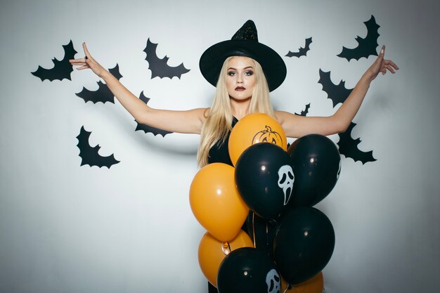 Woman with balloons and bats for Halloween