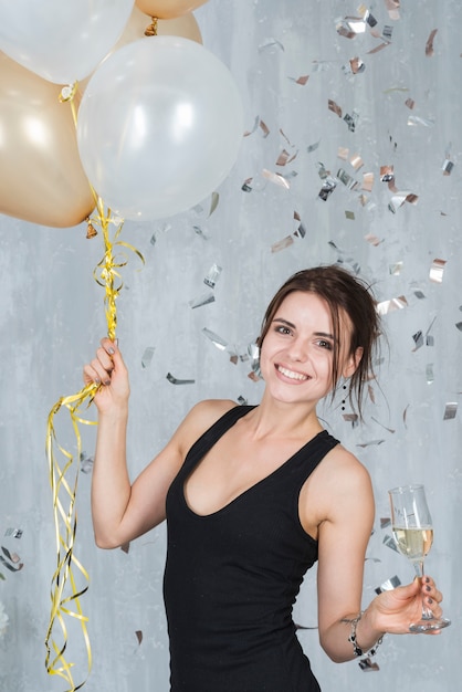 Woman with balloons and champagne