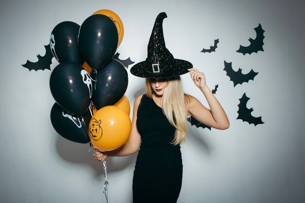 Woman with balloons for Halloween party