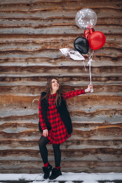 Free photo woman with balloons on her birthday outside