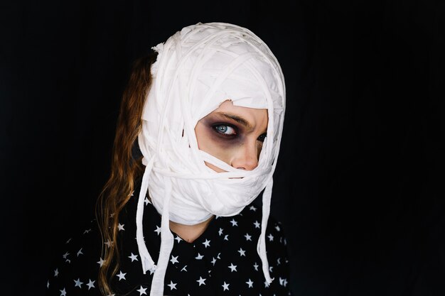 Woman with bandages on face