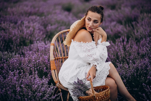 Free photo woman with basket gathering lavander