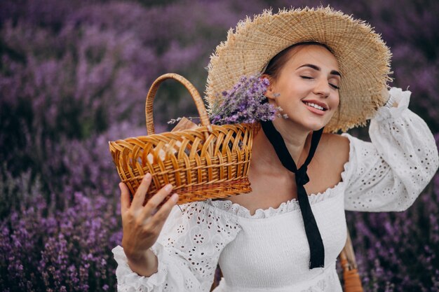 Woman with basket gathering lavander