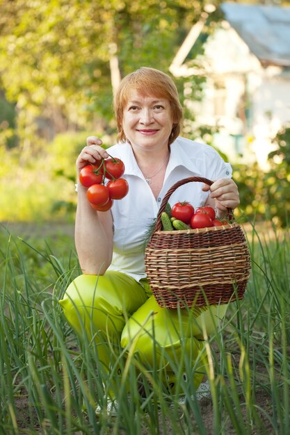 woman with basket of harvested vegetables