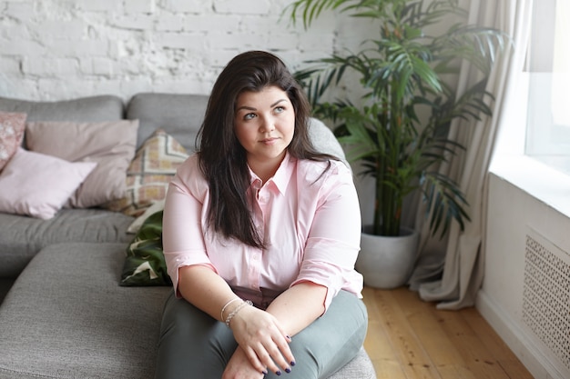 Free photo a woman with beautiful body is posing on the couch