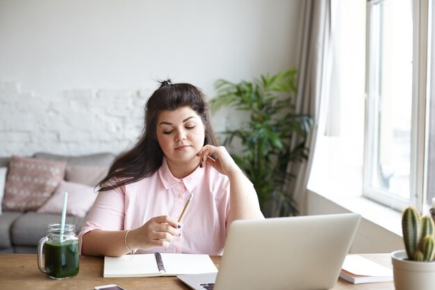 A woman with beautiful body is posing on the couch