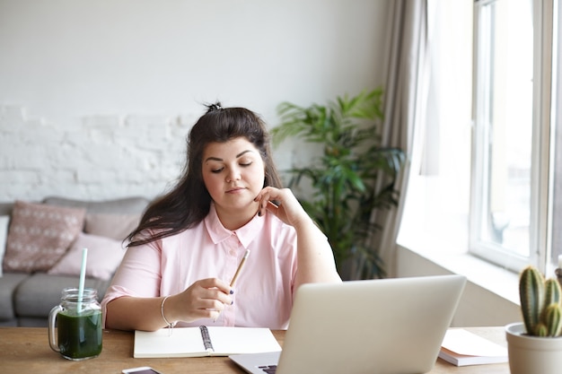 A woman with beautiful body is posing on the couch