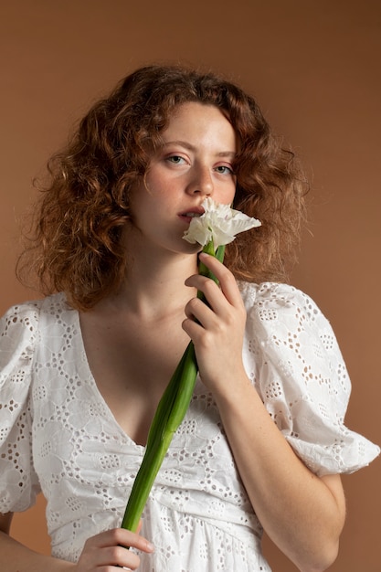 美しいグラジオラスの花を持つ女性