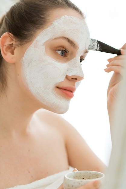 Woman with beauty product, facial mask