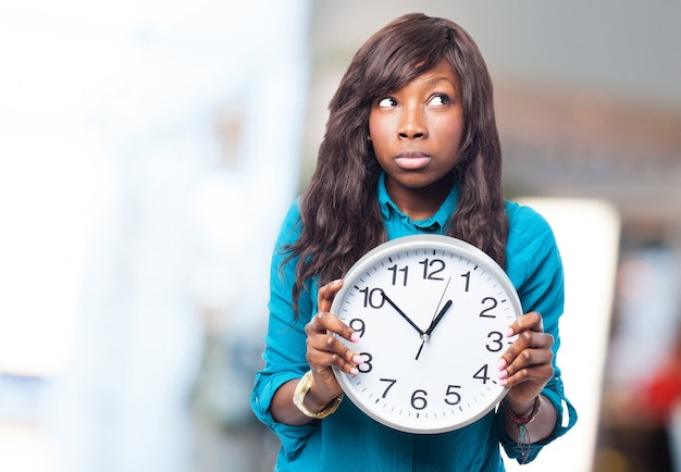 Woman with a big clock in hands